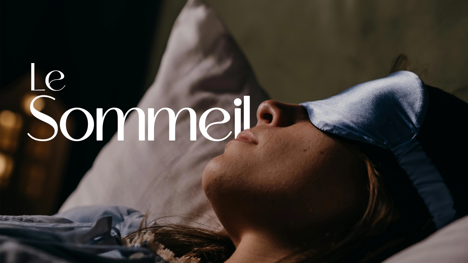 Une femme dort avec un bandeau sur les yeux